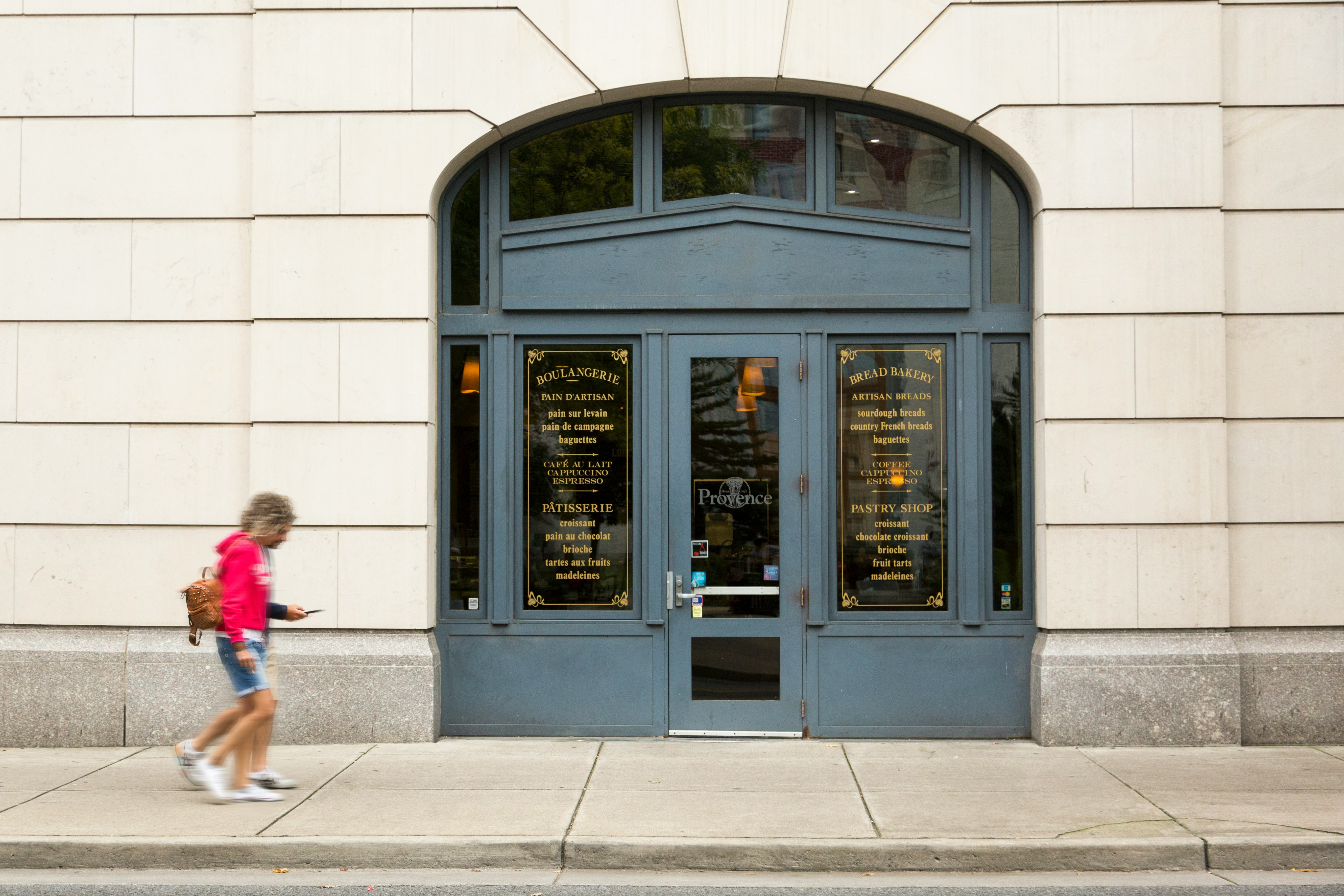 two person walking beside the building